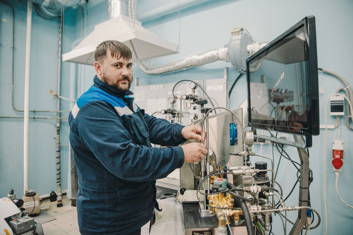Lab technician calibrating fuel testing equipment