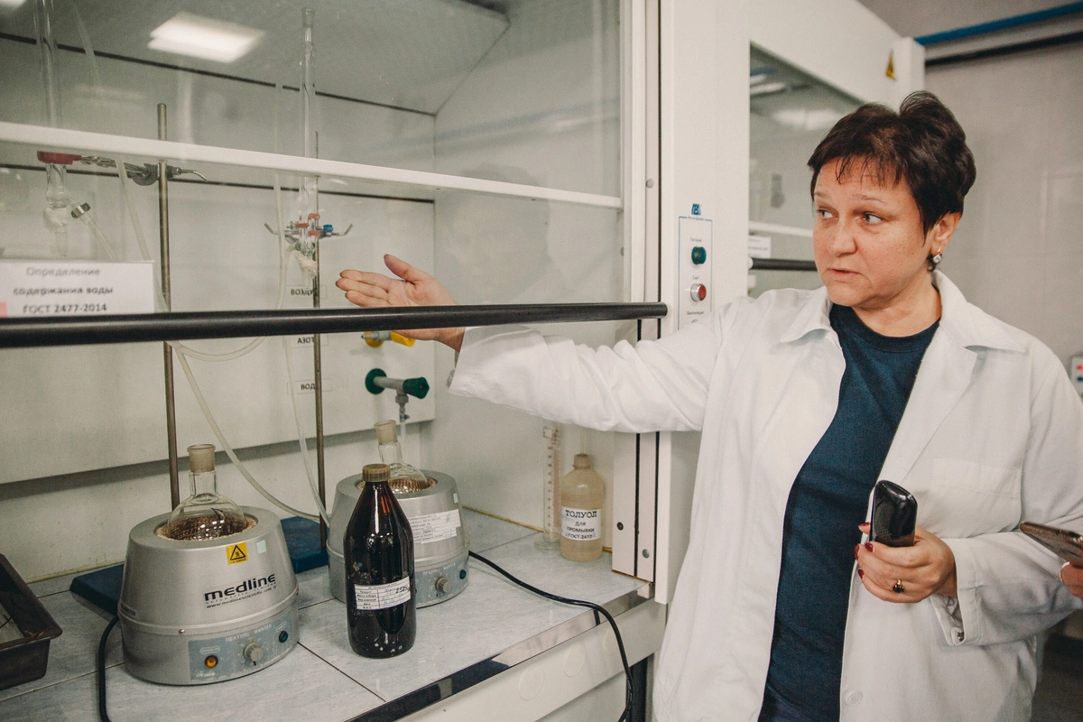 Chemist working at laboratory fume hood